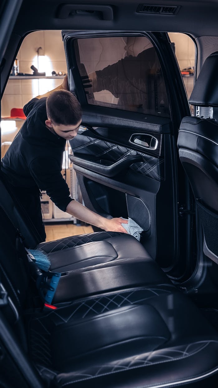 Professional car cleaning service in progress with focus on interior detailing for quality maintenance.
